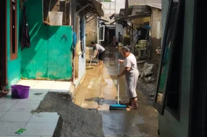 Warga Bersihkan Sisa Lumpur Akibat Banjir Luapan Kali Bekasi